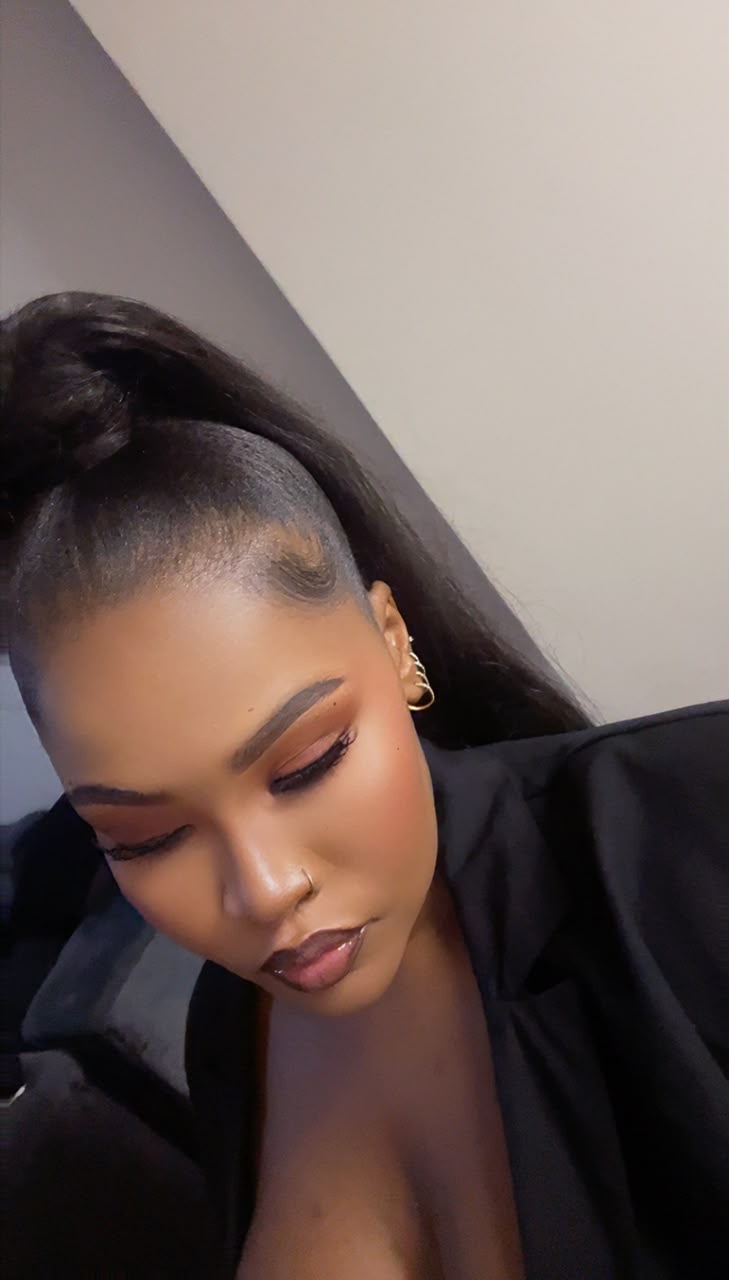 Client with sleek ponytail, warm eyeshadow and glossy lips