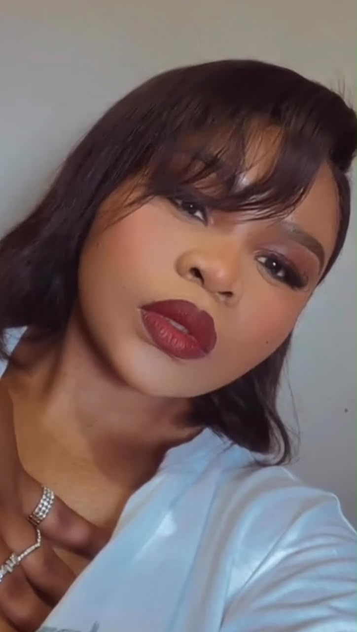 Client wearing smokey eye makeup with a deep red lip